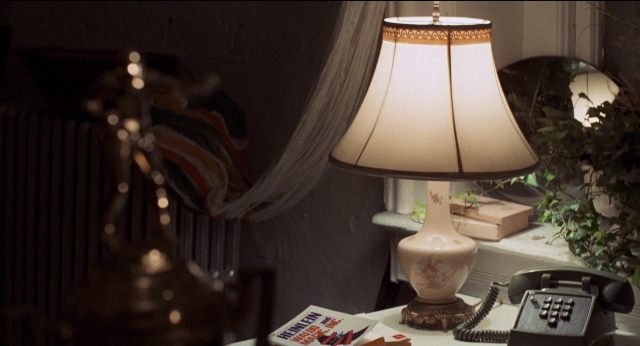 Wide shot frame from Medium Cool — room, phone, mirror