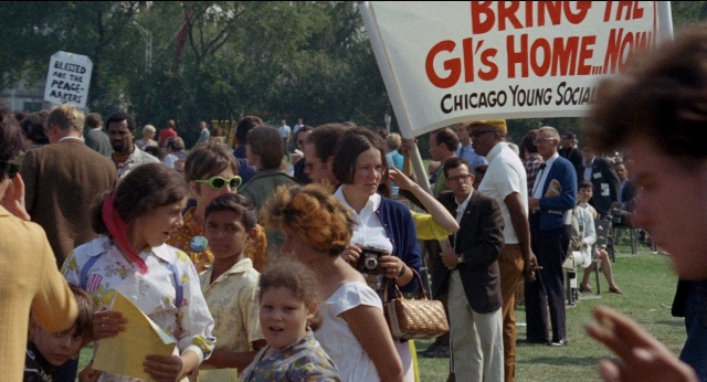 Wide shot frame from Medium Cool — person, human face, glasses