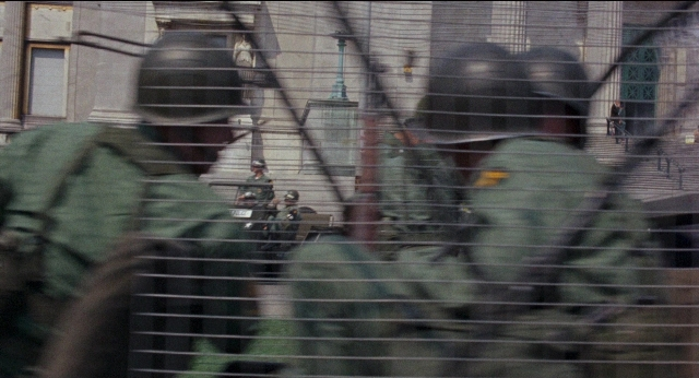 Wide shot frame from Medium Cool — standing, person, window
