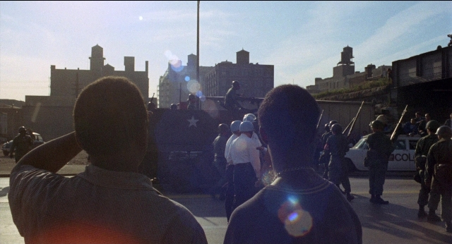 Wide shot frame from Medium Cool — standing, street, person