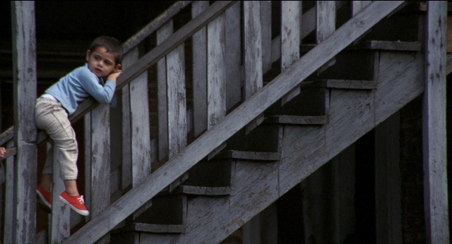 Wide shot frame from Medium Cool — standing, shirt, face