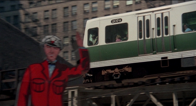 Wide shot frame from Medium Cool — standing, hat, hand