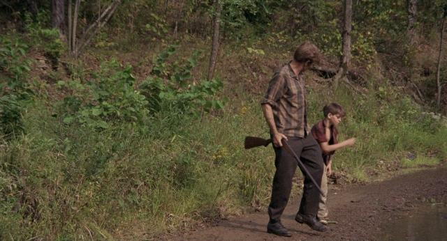 Wide shot frame from Medium Cool — walking, shirt, person