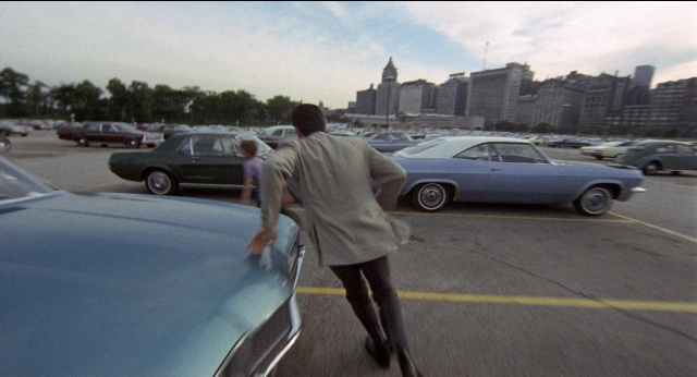 Frame from Medium Cool — walking, car, wheel