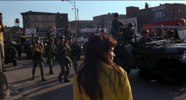 Wide shot frame from Medium Cool — walking, street, hair