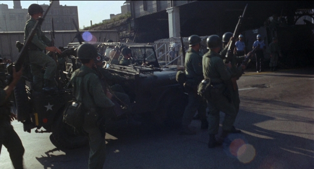 Wide shot frame from Medium Cool — standing, walking, street