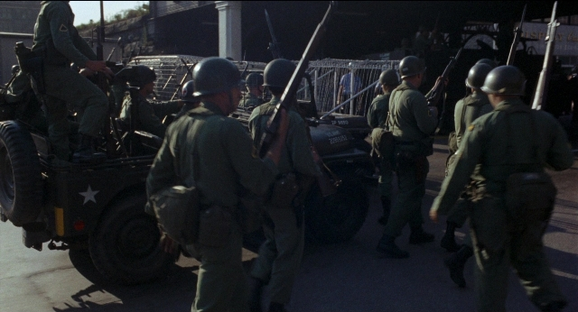 Wide shot frame from Medium Cool — standing, walking, street
