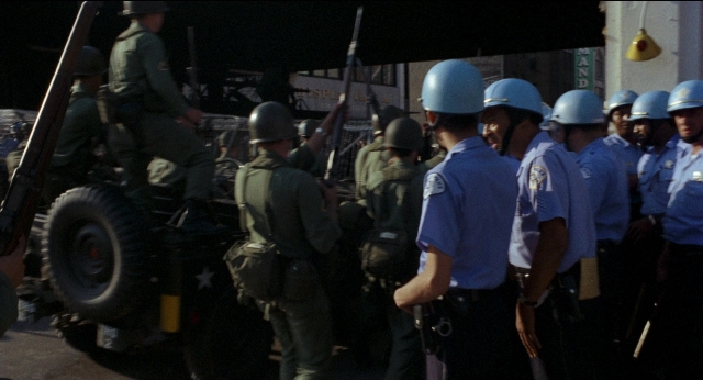 Wide shot frame from Medium Cool — people, action, standing