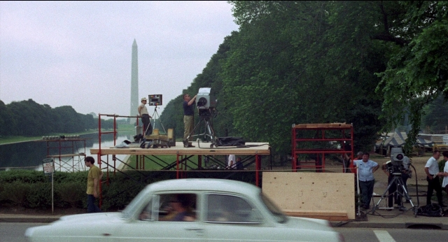 Frame from Medium Cool — standing, street, car