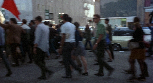 Wide shot frame from Medium Cool — walking, street, person