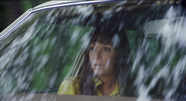 Medium shot frame from Medium Cool — sitting, street, car