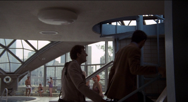 Wide shot frame from Medium Cool — sitting, standing, dialogue