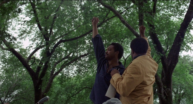 Wide shot frame from Medium Cool — standing, dialogue, person