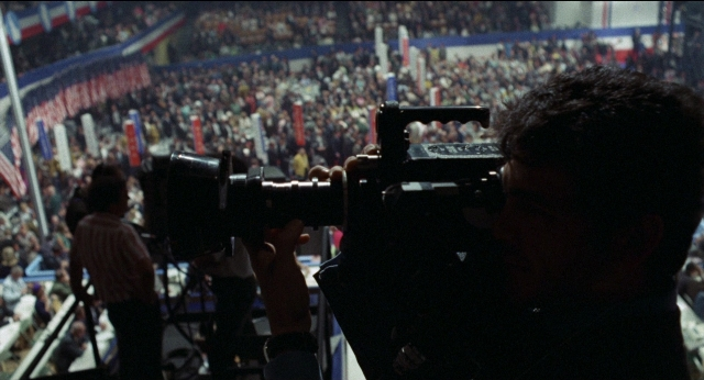 Wide shot frame from Medium Cool — shirt, camera, person