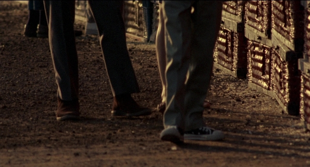 Wide shot frame from Medium Cool — standing, person, footwear