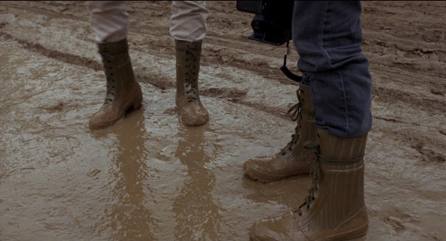 Frame from Medium Cool — standing, water, rain