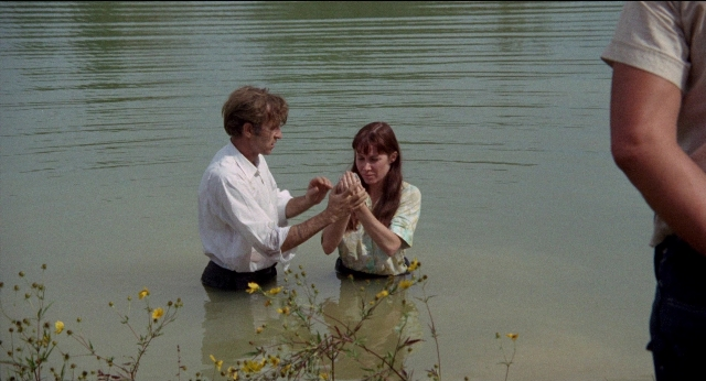 Wide shot frame from Medium Cool — sitting, shirt, water
