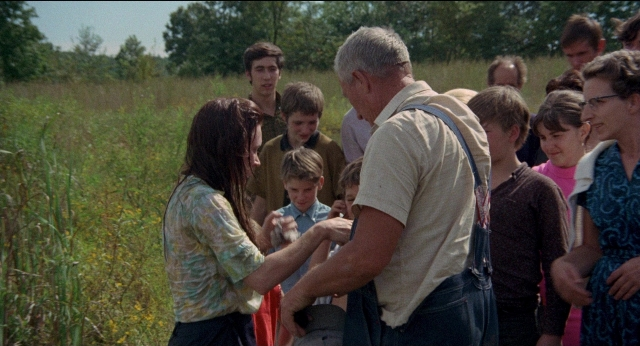 Wide shot frame from Medium Cool — standing, hand, tie
