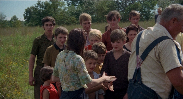 Wide shot frame from Medium Cool — standing, shirt, hair