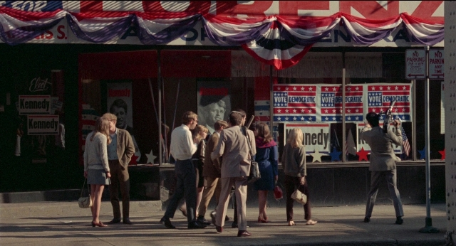 Wide shot frame from Medium Cool — standing, flag, person