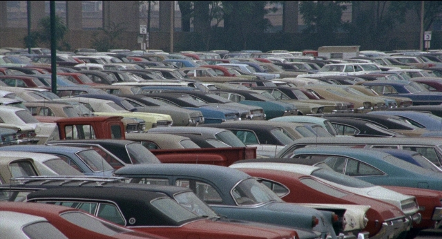 Frame from Medium Cool — car, person