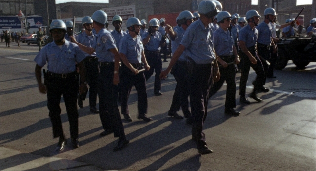Wide shot frame from Medium Cool — walking, street, person