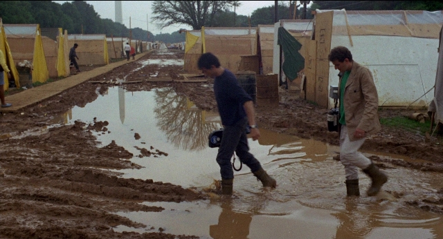 Wide shot frame from Medium Cool — walking, water, person