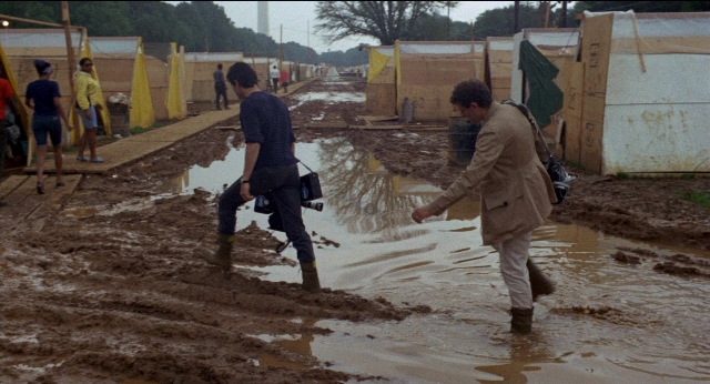 Wide shot frame from Medium Cool — walking, shirt, water