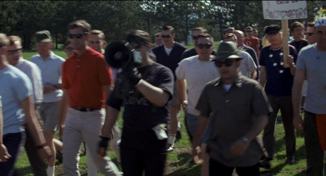 Wide shot frame from Medium Cool — walking, shirt, person