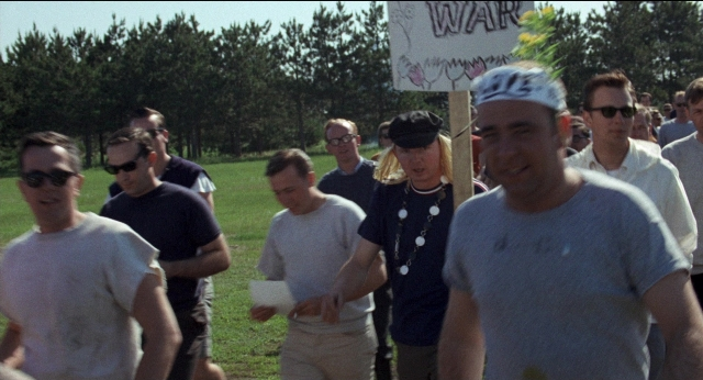 Wide shot frame from Medium Cool — walking, shirt, person