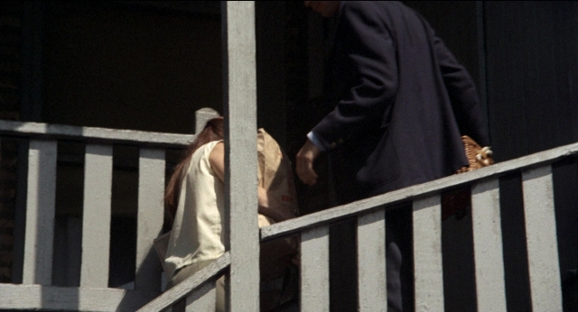 Frame from Medium Cool — walking, hand, suit