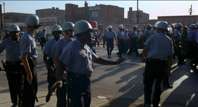 Wide shot frame from Medium Cool — walking, street, person