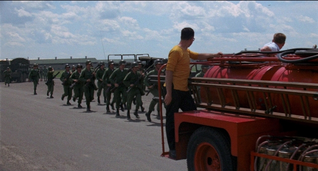 Wide shot frame from Medium Cool — street, fire, truck