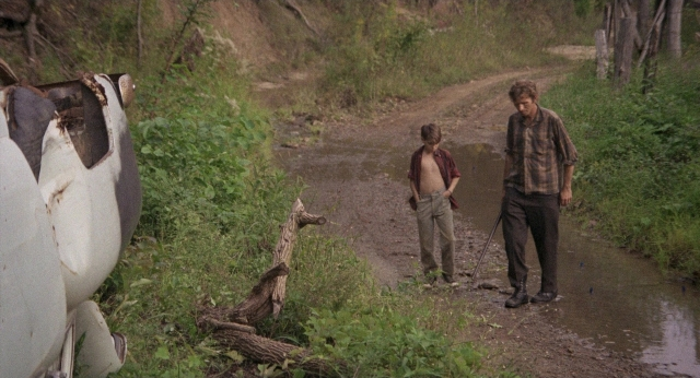 Medium shot frame from Medium Cool — walking, hand, shirt