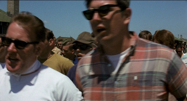 Wide shot frame from Medium Cool — standing, dialogue, shirt