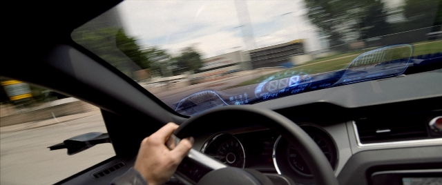 Frame from Need for Speed — car, hand, face