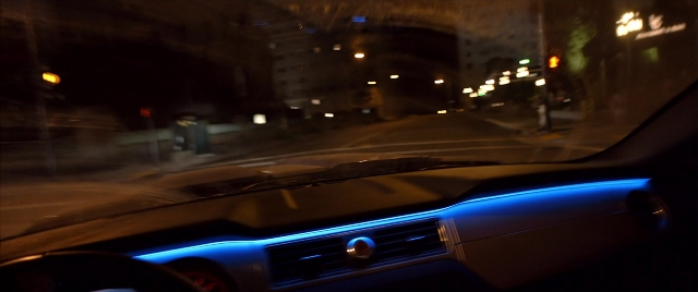 Wide shot frame from Need for Speed — street, car, night