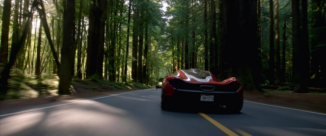 Wide shot frame from Need for Speed — street, car, bird