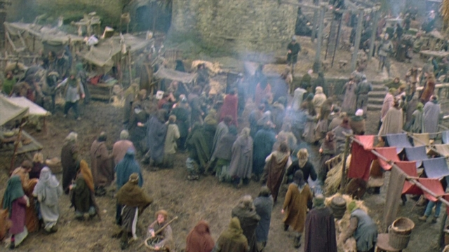 Wide shot frame from Robin Hood: Prince of Thieves — dialogue, fire, person
