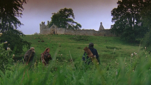 Wide shot frame from Robin Hood: Prince of Thieves — walking, castle, person