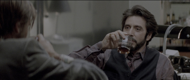 Medium shot frame from Carlito's Way — sitting, table, kitchen