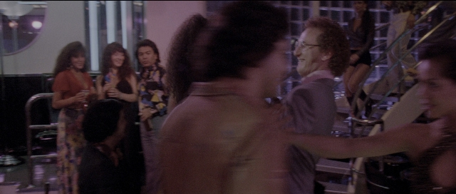 Wide shot frame from Carlito's Way — mirror, shirt, hair