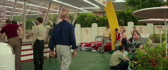 Wide shot frame from The Founder — sitting, standing, dialogue