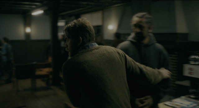 Wide shot frame from Doctor Sleep — room, table, beard