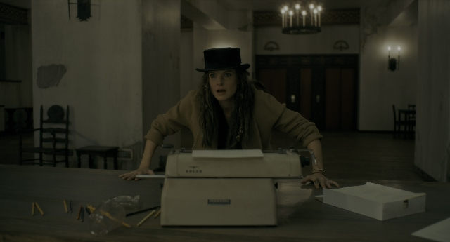 Wide shot frame from Doctor Sleep — sitting, room, table