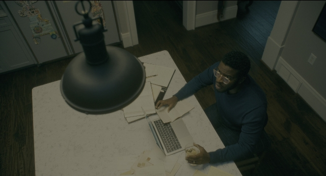 Medium shot frame from Doctor Sleep — sitting, room, table