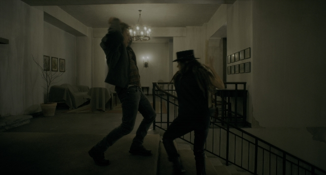 Wide shot frame from Doctor Sleep — room, table, couch