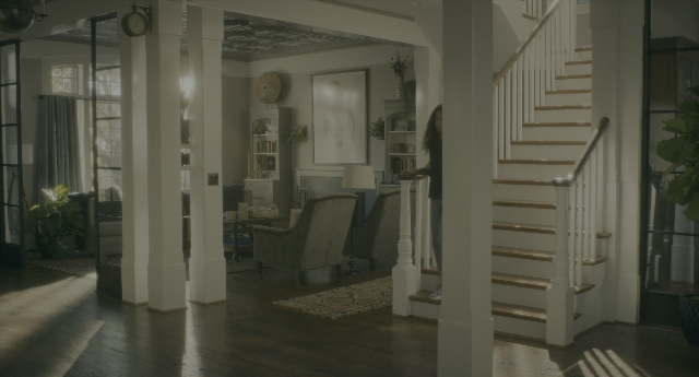 Wide shot frame from Doctor Sleep — standing, room, table
