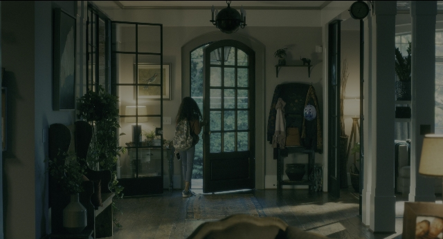 Medium shot frame from Doctor Sleep — standing, room, table