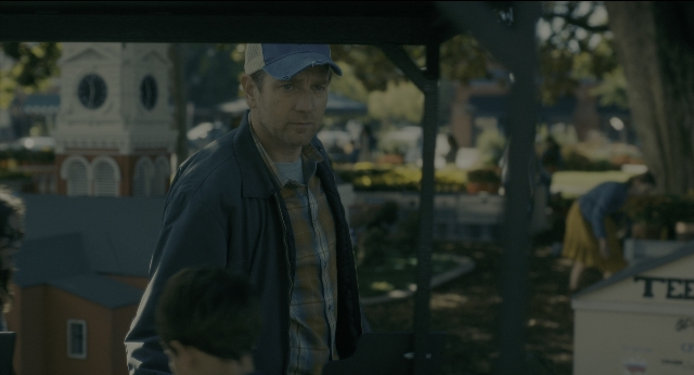 Wide shot frame from Doctor Sleep — standing, hat, face
